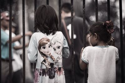 Rear view of woman looking through window
