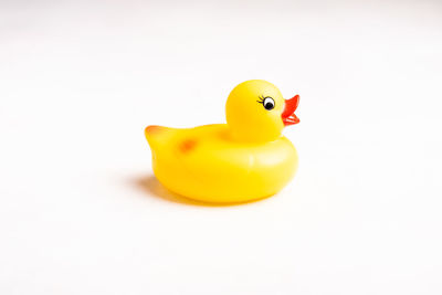 Close-up of yellow toy over white background