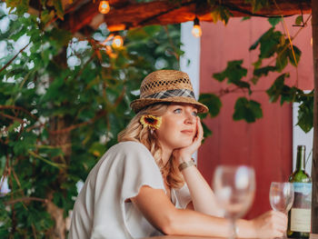 Portrait of young woman wearing hat