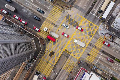 Aerial view of vehicles on road by buildings