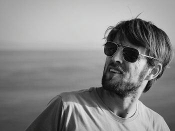 Man wearing sunglasses against sea