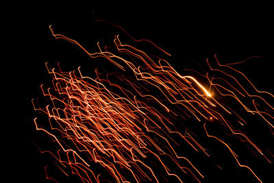 Low angle view of firework display against sky at night