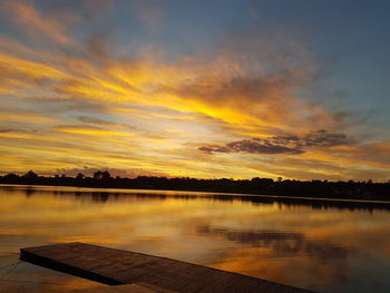 Scenic view of lake against orange sky