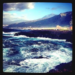 Scenic view of sea against cloudy sky