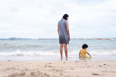 Rear view of couple on beach
