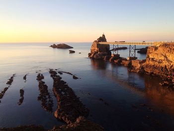 Footbridge between rocks by sea