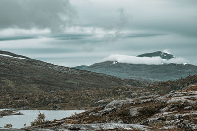 Scenic view of snowcapped mountains by sea against sky