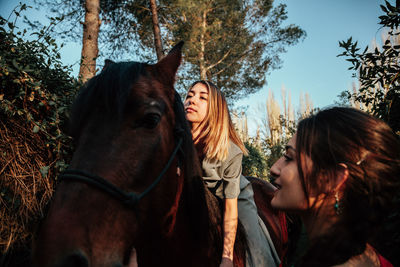 Women with horse in forest