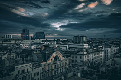 Cityscape against cloudy sky