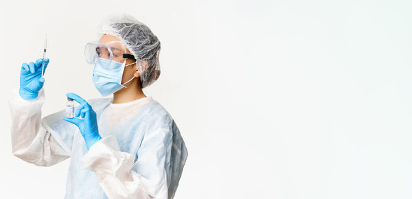 Rear view of woman wearing mask against white background