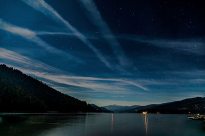 Scenic view of lake against sky at night