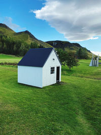 House on field against sky with cloudy green grass view land town living home travel holiday sun 