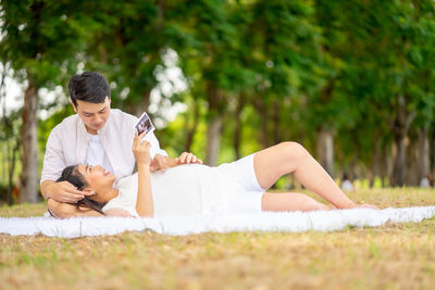 Side view of young woman lying on land