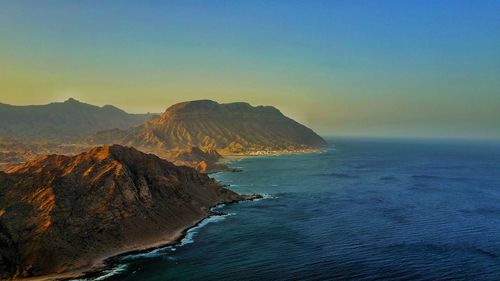 Scenic view of sea against clear sky at sunset