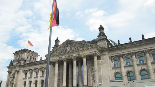 Low angle view of flags against sky