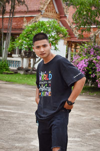 Portrait of young man standing in park