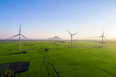 Windmill on field against sky