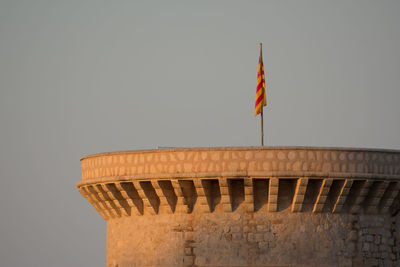 Low angle view of flag against clear sky