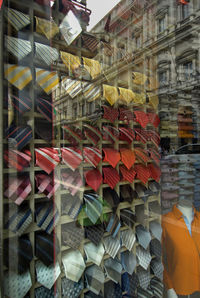 Necktie on rack in shop seen through glass window