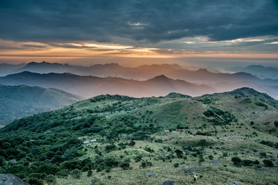 Scenic view of mountains against sky at sunset