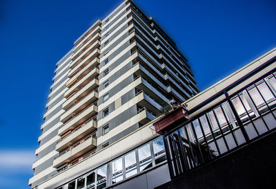 Low angle view of modern building against clear blue sky