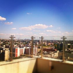 View of cityscape against blue sky