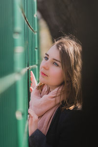 Beautiful woman looking away while standing outdoors