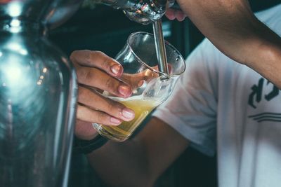 Midsection of man preparing food in glass