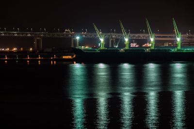 View of illuminated harbor at night