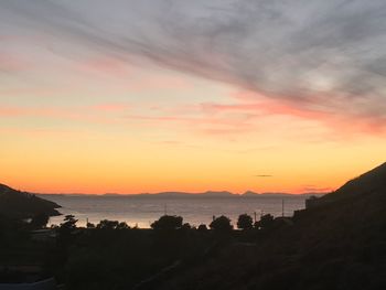 Scenic view of dramatic sky over sea during sunset