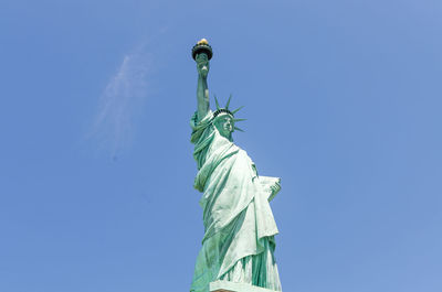 Low angle view of statue against blue sky