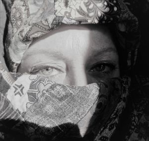 Close-up portrait of woman covering face