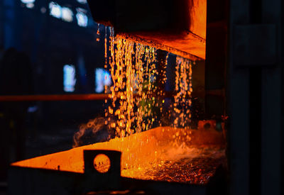 Illuminated lighting equipment on glass at night
