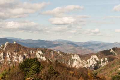 Scenic view of mountains against cloudy sky