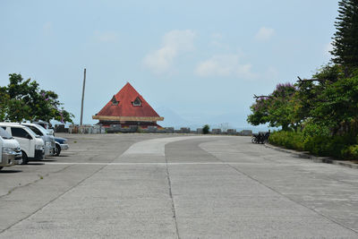 Road by building against sky