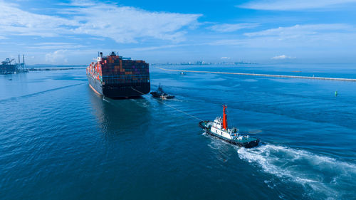 High angle view of boats in sea against sky