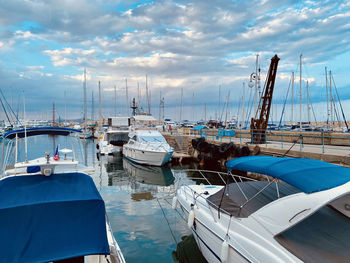 Mediterranian sea marina port waterfont moored yachts harbor view crane under clouded sky