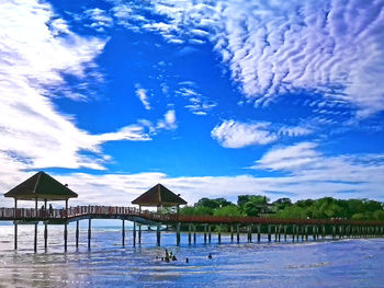 Built structure by sea against blue sky