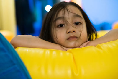 Close up of little asian girl, looking in camera with cute expression.