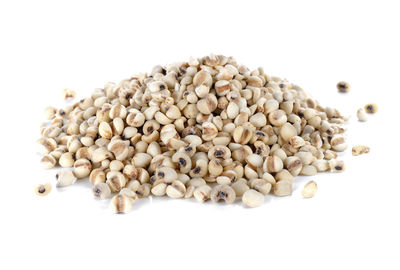 High angle view of roasted coffee beans against white background