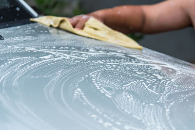 Cropped hand washing car