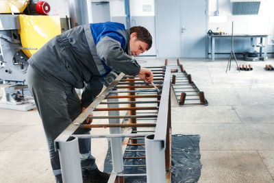 Side view of man working at construction site