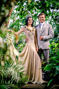 Couple standing against trees