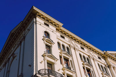 Low angle view of building against clear blue sky