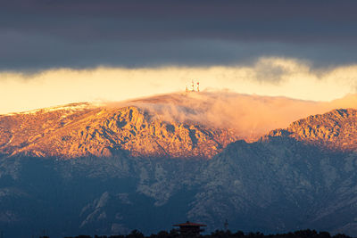 Scenic view of snowcapped mountains against sky during sunset