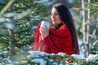 Side view of a young woman in snow