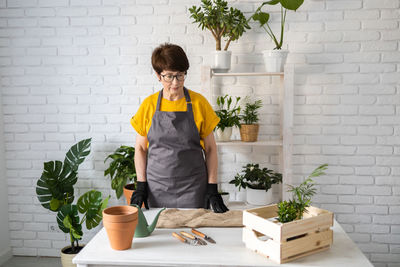 Young woman holding potted plant