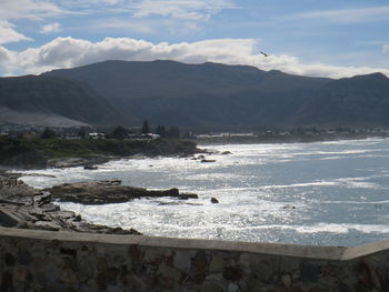 Scenic view of sea and mountains against sky