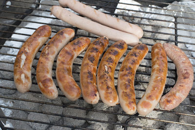 Close-up of man preparing food on barbecue grill