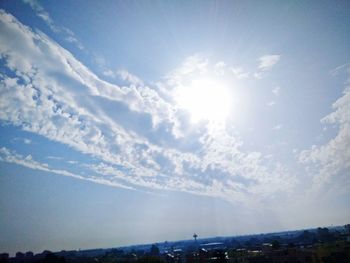 Low angle view of bright sun in sky